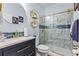 Updated bathroom featuring sleek vanity, blue glass accents, and stylish marble-tiled shower with gold accents at 4695 Ferncrest Pl, Douglasville, GA 30135