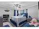 Well-lit bedroom featuring bright blue accents, ceiling fan, and comfortable bedding at 4695 Ferncrest Pl, Douglasville, GA 30135