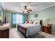 Inviting bedroom with a ceiling fan, teal-colored walls, and comfortable bedding at 4695 Ferncrest Pl, Douglasville, GA 30135