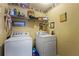 Functional laundry room with washer, dryer, and storage shelves at 4695 Ferncrest Pl, Douglasville, GA 30135
