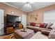Cozy living room featuring a comfortable sofa and entertainment center at 4695 Ferncrest Pl, Douglasville, GA 30135