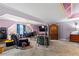 Spacious living room with two sitting areas, plush carpeting, and a large TV at 4695 Ferncrest Pl, Douglasville, GA 30135