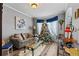 Charming living room with a festive tree and comfortable seating area at 4695 Ferncrest Pl, Douglasville, GA 30135