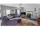 Inviting living room with a plush sectional sofa and decorative fireplace at 4695 Ferncrest Pl, Douglasville, GA 30135