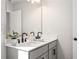 Modern bathroom featuring double sinks, matte black hardware, and neutral color palette at 733 Stickley Oak Way, Woodstock, GA 30189