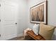 Inviting entryway features a leather bench with decor and an eye-catching piece of framed artwork on the wall at 733 Stickley Oak Way, Woodstock, GA 30189
