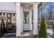 Inviting front entrance with a gray door, classic columns, and stylish black trim at 733 Stickley Oak Way, Woodstock, GA 30189
