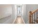 Bright hallway with light wood floors and modern lighting leading to the front door at 733 Stickley Oak Way, Woodstock, GA 30189