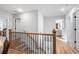 Bright hallway with hardwood floors leads to bedrooms and bathrooms at 733 Stickley Oak Way, Woodstock, GA 30189
