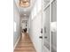 Hallway with view to living area, wood floors and neutral paint at 733 Stickley Oak Way, Woodstock, GA 30189