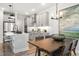 Open-concept kitchen with stainless appliances, white countertops, and bar stool seating at 733 Stickley Oak Way, Woodstock, GA 30189