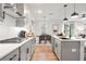 Modern eat-in kitchen with grey cabinets, stainless appliances, white backsplash, and hardwood floors at 733 Stickley Oak Way, Woodstock, GA 30189