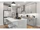 Well-designed kitchen with grey cabinets, stainless steel appliances, and a breakfast bar for seating at 733 Stickley Oak Way, Woodstock, GA 30189