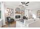 Inviting living room with a fireplace, plush seating, and natural light from large windows at 733 Stickley Oak Way, Woodstock, GA 30189