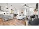 Bright, open-concept living area with wood floors, comfortable seating, and ample natural light at 733 Stickley Oak Way, Woodstock, GA 30189