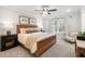 Comfortable main bedroom with a ceiling fan, carpeted floor, and a tranquil ambiance with a seating chair at 733 Stickley Oak Way, Woodstock, GA 30189