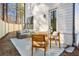 Outdoor living area with patio, wooden chairs and couch with adjacent wooden fence at 733 Stickley Oak Way, Woodstock, GA 30189