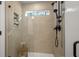 Modern shower with glass door and window with handheld sprayer and neutral tiling at 733 Stickley Oak Way, Woodstock, GA 30189