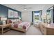 Charming bedroom with a colorful accent wall, a ceiling fan, and a comfy armchair at 808 Tupelo Way, Villa Rica, GA 30180