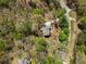 Aerial view of a wooded home surrounded by mature trees at 3560 Chattahoochee Rd, Cumming, GA 30041