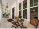 Cozy outdoor seating on the back porch, featuring brick flooring and views of the surrounding landscape at 3560 Chattahoochee Rd, Cumming, GA 30041