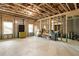 Unfinished basement featuring wood beams and concrete floor, awaiting your personal touch at 3560 Chattahoochee Rd, Cumming, GA 30041