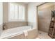 Serene bathroom with soaking tub, tiled shower, and modern fixtures for a spa-like experience at 3560 Chattahoochee Rd, Cumming, GA 30041
