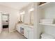 Bright bathroom featuring double vanities, granite countertops, and a walk-in closet at 3560 Chattahoochee Rd, Cumming, GA 30041