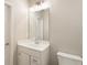 Bathroom featuring a single sink vanity and plenty of light at 3560 Chattahoochee Rd, Cumming, GA 30041