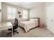 Neutral bedroom featuring a comfortable bed, desk area, and ample natural light at 3560 Chattahoochee Rd, Cumming, GA 30041