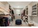 Walk-in closet with custom shelving, drawers, and centered ottoman at 3560 Chattahoochee Rd, Cumming, GA 30041