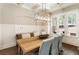 Stylish dining room with views of the outdoor scenery, complete with hardwood floors and modern lighting at 3560 Chattahoochee Rd, Cumming, GA 30041