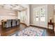 Open-concept dining room with hardwood floors, coffered ceilings, and views to the front yard at 3560 Chattahoochee Rd, Cumming, GA 30041