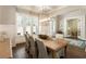 Elegant dining room with hardwood floors, a modern chandelier, and double doors to another living space at 3560 Chattahoochee Rd, Cumming, GA 30041