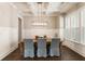 Bright dining room with coffered ceilings, a modern chandelier, and large windows for natural light at 3560 Chattahoochee Rd, Cumming, GA 30041