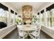 Bright dining room featuring a fireplace and a beautiful view of the surrounding greenery at 3560 Chattahoochee Rd, Cumming, GA 30041