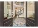 Elegant entryway with hardwood floors, an area rug, and views of the staircase and dining area at 3560 Chattahoochee Rd, Cumming, GA 30041