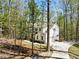 Aerial view of a beautiful home with long driveway, and lush green surroundings at 3560 Chattahoochee Rd, Cumming, GA 30041