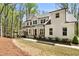 Attractive home with white siding, covered porch, surrounded by green trees at 3560 Chattahoochee Rd, Cumming, GA 30041