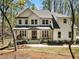 Charming two-story home with white siding, covered front porch, and well-manicured landscaping at 3560 Chattahoochee Rd, Cumming, GA 30041