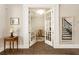 Inviting foyer featuring beautiful hardwood floors, glass french doors, and elegant decor at 3560 Chattahoochee Rd, Cumming, GA 30041