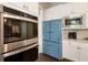 Gourmet kitchen featuring stainless steel appliances and vintage-style refrigerator at 3560 Chattahoochee Rd, Cumming, GA 30041
