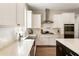 Bright kitchen features white cabinets, stainless steel appliances, and quartz countertops at 3560 Chattahoochee Rd, Cumming, GA 30041