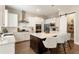 Modern kitchen featuring a large center island, white cabinets, and stainless steel appliances at 3560 Chattahoochee Rd, Cumming, GA 30041
