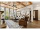 Open-concept living room with large windows, a fireplace, and access to the kitchen at 3560 Chattahoochee Rd, Cumming, GA 30041