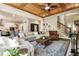 Open-concept living room with hardwood floors, fireplace and access to kitchen and stairs at 3560 Chattahoochee Rd, Cumming, GA 30041