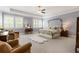 Spacious main bedroom features tray ceiling, sitting area, and large windows with shutter blinds at 3560 Chattahoochee Rd, Cumming, GA 30041