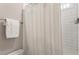 Bathroom with white shower curtain and modern tile at 3560 Chattahoochee Rd, Cumming, GA 30041