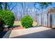 Backyard with patio area, decorative bushes and a view of the woods at 6355 Valhalla Dr, Douglasville, GA 30135