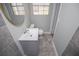 Updated bathroom featuring new vanity, gray tiled floor, and natural light at 6355 Valhalla Dr, Douglasville, GA 30135